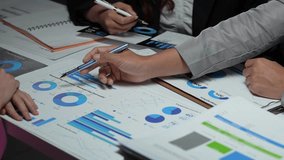 Close up on businesspeople's hands analyzing financial charts and graphs during a team meeting - Powered by Shutterstock - Get 15% off with code: PIKWIZARD15