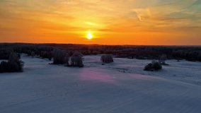Golden sunrise casts warm light over frost-covered fields and trees. Latvia - Powered by Shutterstock - Get 15% off with code: PIKWIZARD15