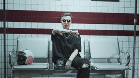 Lonely musician performing gangster rap song in underground station in night. Medium portrait of handsome male hip-hop singer, self-expression in music, modern style and contemporary art performance - Powered by Shutterstock - Get 15% off with code: PIKWIZARD15