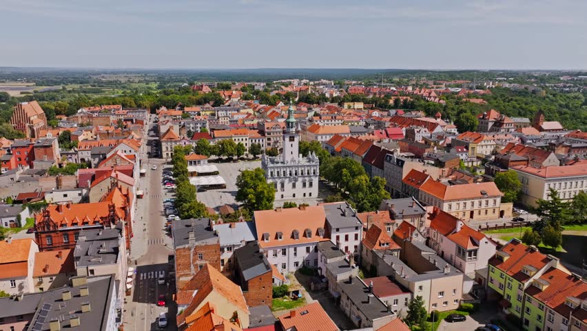 Cinematic aerial of Chełmno Town Hall in heart of historic Old Market Square