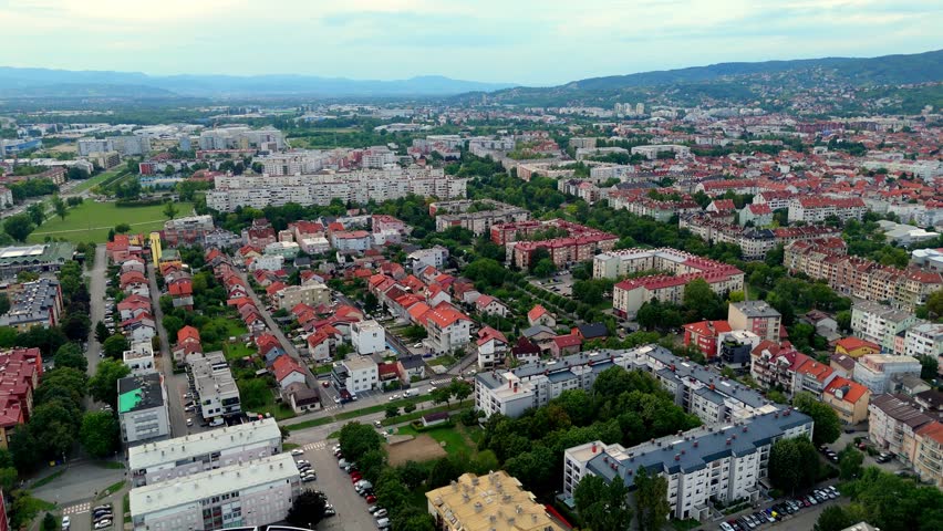 Aerial drone view of Zagreb skyline modern buildings, and warm evening light over Croatia’s capital city.