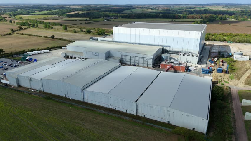Aerial drone view of large cold storage warehouses and industrial factory buildings in rural surroundings near Grantham, United Kingdom