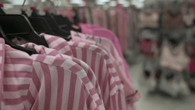 fashion retail setup, stylish shopping environment featuring neatly arranged pastel clothing, voguish retail scene displaying harmoniously organized striped garments on sophisticated hangers - Powered by Shutterstock - Get 15% off with code: PIKWIZARD15