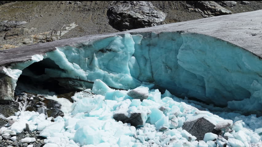 Glacial ice melting in Morteratsch, Switzerland under rocky terrain