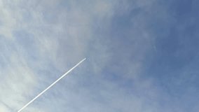 The plane flies against a background of thin clouds near the moon, leaving conversion traces - Powered by Shutterstock - Get 15% off with code: PIKWIZARD15