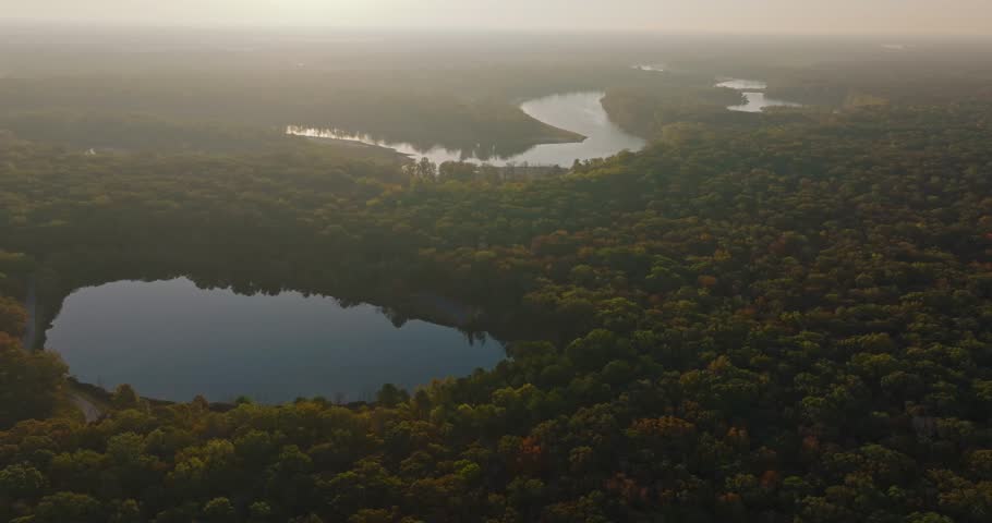 Aerial view of tranquil forests and river in Arkansas at sunrise