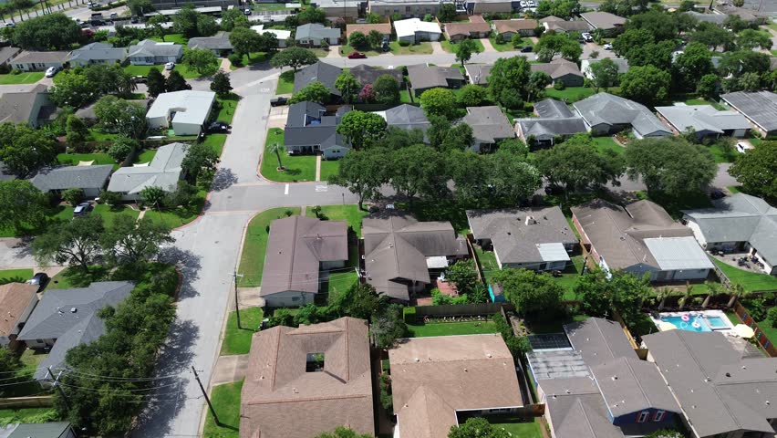 Suburban neighborhood in the West End Galveston, Texas. One story homes on larger lots, wider streets, and suburbs feel distinct from the historic core, demonstrating the island expansion. USA