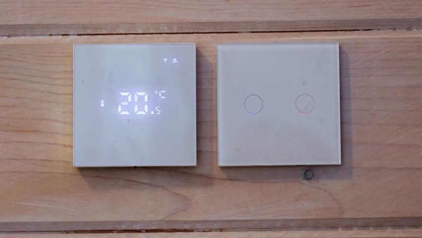 User's hands adjusting thermostat to setting it to 22C. Adjusting wall thermostat thermostat. High quality 4k footage