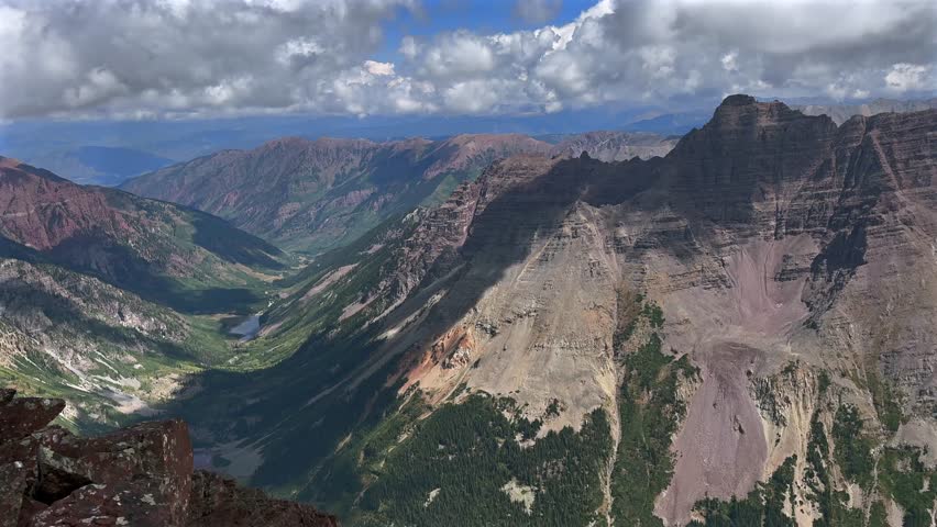 Pyramid Peak Aspen Snowmmass Maroon Peak Maroon Bells Wilderness hiking fourteener Colorado summer aerial drone clear sunny cloudy valley Elk Range Rocky Mountains rugged terrain slide left motion