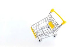hand inserts token Bitcoin into a small shopping cart symbolizing crypto trading and digital shopping, and digital finance in a modern economy. - Powered by Shutterstock - Get 15% off with code: PIKWIZARD15