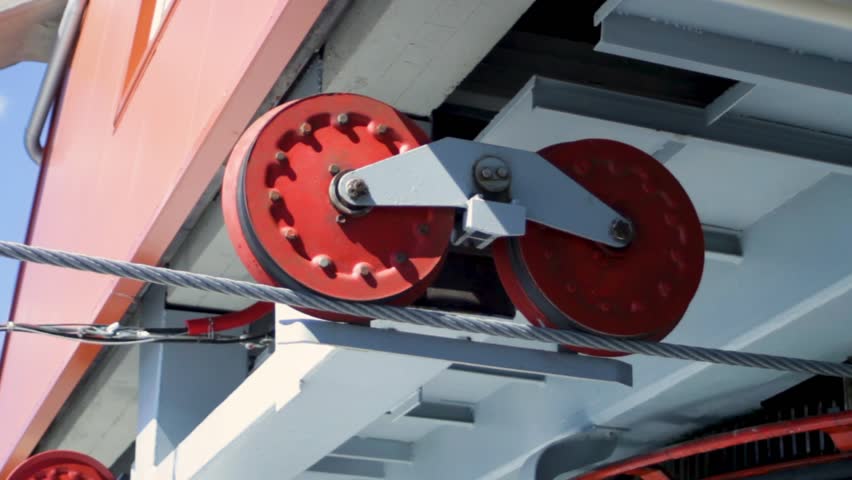 Lift mechanism operates cleanly, showing steel tension and sustainable motion. Pulley system supports elevation without emissions. Concept of eco-elevation as engineered responsibility.