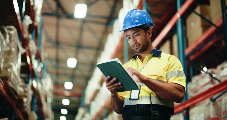 Man, tablet and thinking with warehouse inspection, typing and stock with low angle for logistics. Person, tech and happy with application for inventory management, shipping or supply chain at plant