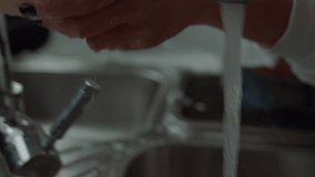 Woman scrubbing dishes in kitchen sink while cleaning up at home - Powered by Shutterstock - Get 15% off with code: PIKWIZARD15