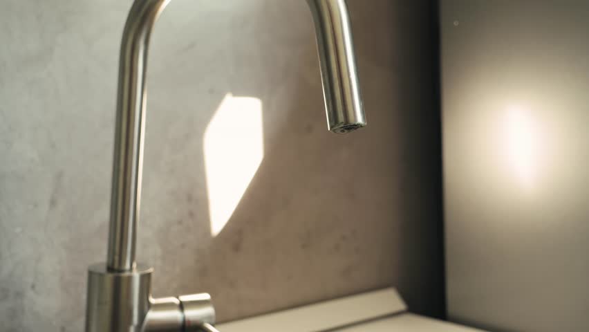 Woman pouring tap water into glass, pure drinking water concept. High quality 4k footage