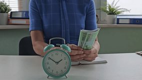 Counting cash and managing time in a modern office environment - Powered by Shutterstock - Get 15% off with code: PIKWIZARD15