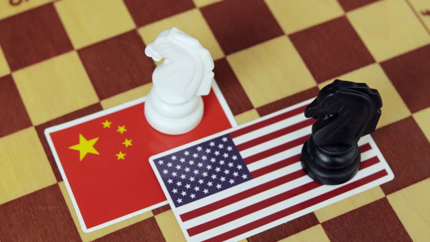 Chinese flag and a Flag of USA on chessboard. Tariffs war and conflict between those two countries.