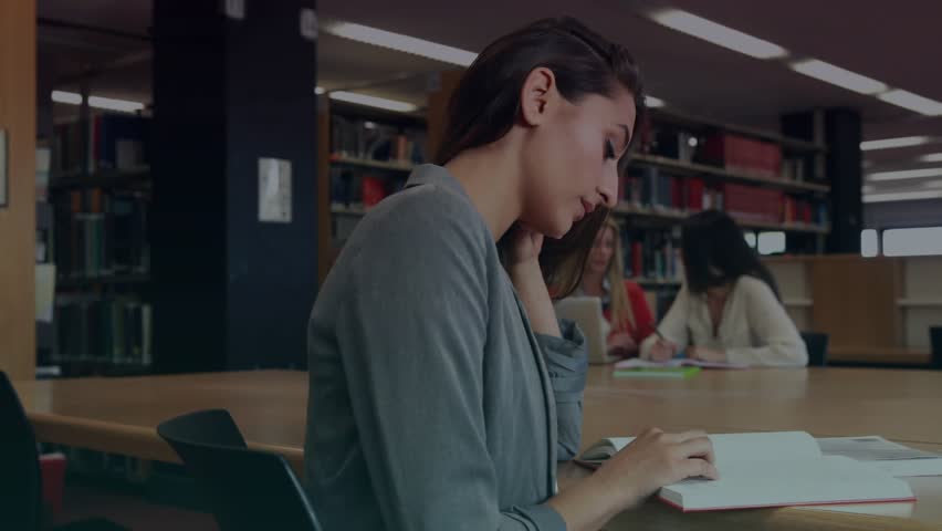 Female student reading book at library, HUD overlay shifting fading to reveal education focus. Study, laptop, notebook, shelves, collaboration, calm, modern
