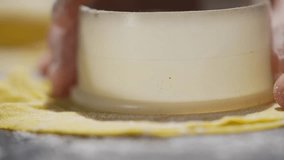 A person is cutting a pastry with a cookie cutter. The pastry is yellow and the cutter is white - Powered by Shutterstock - Get 15% off with code: PIKWIZARD15