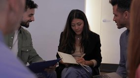 Diverse office team brainstorming together in circle. Coworkers sharing ideas in an informal meeting at the workplace. Collaboration and creativity concept. - Powered by Shutterstock - Get 15% off with code: PIKWIZARD15