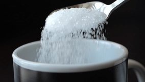 Slow Motion Putting Sugar in to Black Coffee. Sugar Falling Down Into Coffee Cup. Coffee Caffeine Addiction Junk Food. Concept of Unhealthy Eating, Diabetes, Obesity, Heart Disease.  - Powered by Shutterstock - Get 15% off with code: PIKWIZARD15