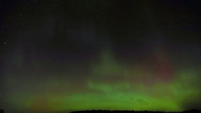 Timelapse video of Aurora Borealis over St. Croix County, Wisconsin on November 12, 2025. Red, green and blue northern lights and stars illuminate the night sky. - Powered by Shutterstock - Get 15% off with code: PIKWIZARD15