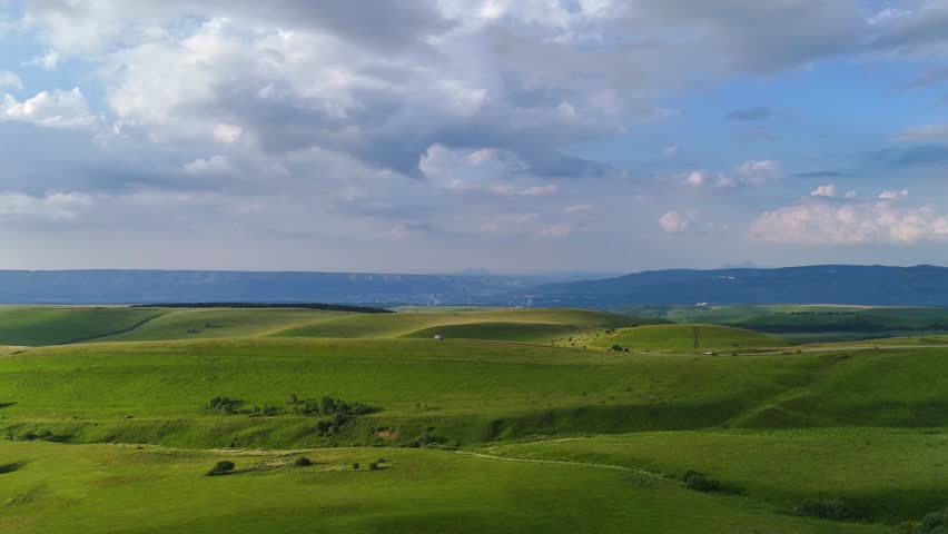 Drone flight over a motorhome in the Caucasus Mountains at sunset
