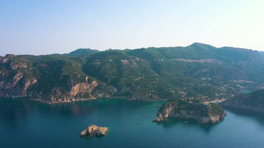 quite peaceful sunrise over Paleokastritsa bay with the clear sky and calm at sea, Corfu, Greece
