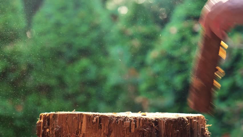 Solid fuel.Preparing firewood for the heating season.man chops wood with an axe in the street. 4k footage