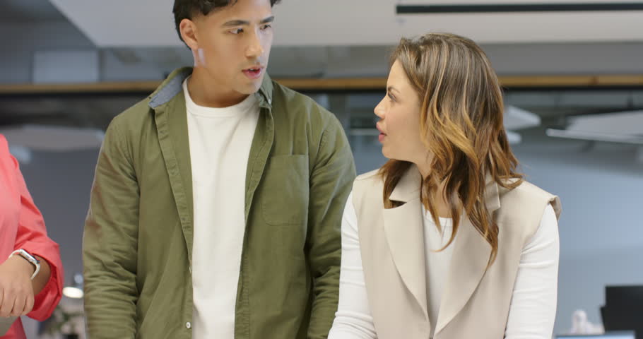 After pen handover Diverse coworkers writing sticky notes, sorting charts, planning at white table. Collaboration, teamwork, brainstorming, office, productivity, modern, planning