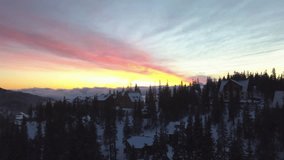 Sunset over snowy mountains with charming lodges nestled among trees - Powered by Shutterstock - Get 15% off with code: PIKWIZARD15