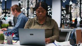 Diverse business colleagues reviewing files and charts during a strategy briefing. Employees in multinational company share insights and coordinate tasks using pc and visual data tools. Camera B. - Powered by Shutterstock - Get 15% off with code: PIKWIZARD15