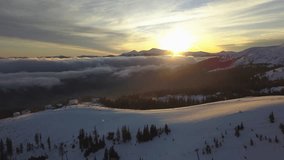 Sunset over snowy mountain range with low-lying clouds in the valley - Powered by Shutterstock - Get 15% off with code: PIKWIZARD15