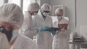 A diverse group of scientists stands by a bright lab window, discussing research data and collaborating on an important scientific project.
 - Powered by Shutterstock - Get 15% off with code: PIKWIZARD15