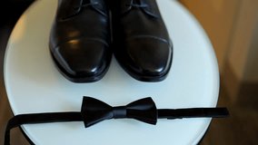 Morning of the Groom. Groom wedding accessories. Black Shoes and silk bow tie. Around camera move - Powered by Shutterstock - Get 15% off with code: PIKWIZARD15