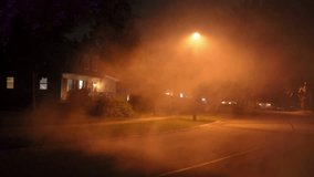Foggy suburban street at night illuminated by a streetlight. Thick mist drifts across quiet neighborhood creating a mysterious, eerie atmosphere. Halloween, thriller, silence - Powered by Shutterstock - Get 15% off with code: PIKWIZARD15