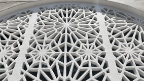 A geometric Islamic pattern crafted from GFRC forms an attractive, repeating architectural element on a wall. This decorative feature enhances the structure with traditional aesthetic design. - Powered by Shutterstock - Get 15% off with code: PIKWIZARD15