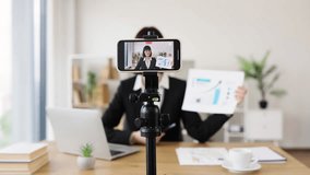Caucasian woman recording business presentation, sharing strategies and data analysis from laptop setup - Powered by Shutterstock - Get 15% off with code: PIKWIZARD15