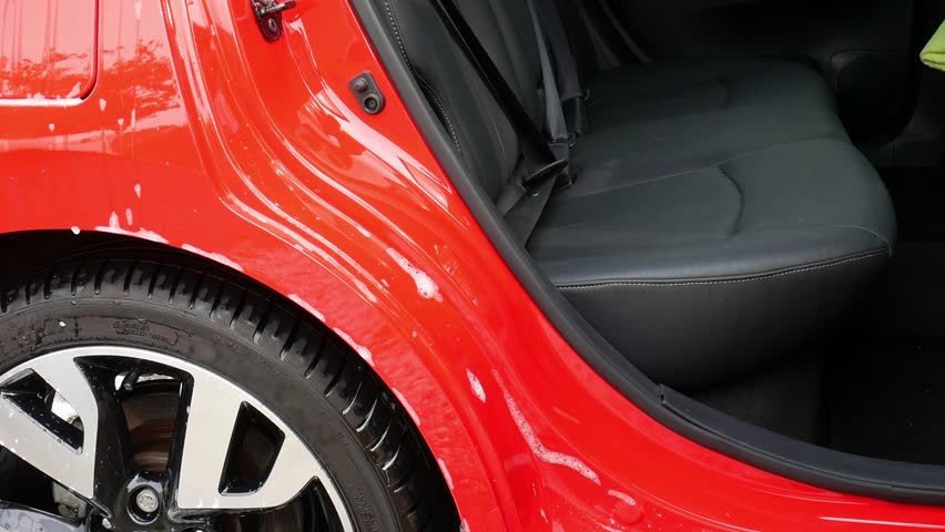 Cleaning rear door shut and sill with a microfiber wash mitt and lots of shampoo suds