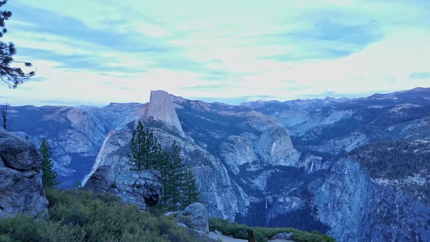 From Washburn Point, Yosemite’s terrain unfolds in layers, with Half Dome, forested slopes, and rugged cliffs stretching far into the distance.