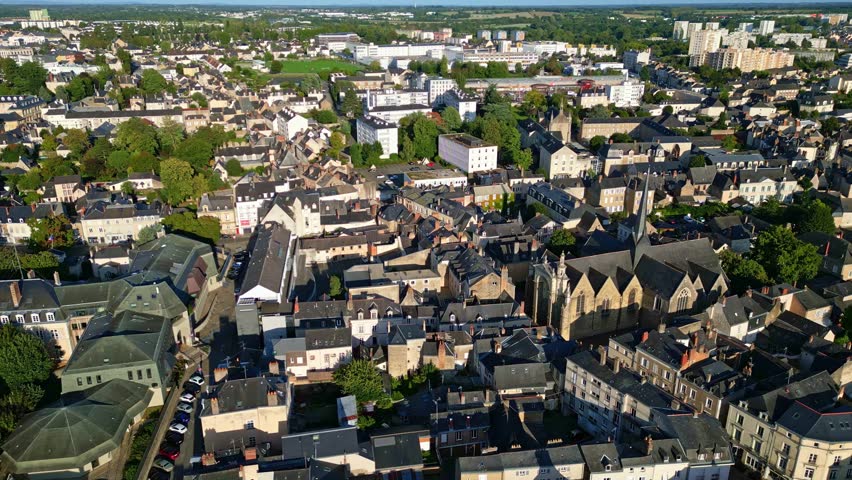 Église Saint-Vénérand, church and surrounding cityscape, Laval, France. Aerial drone sideways