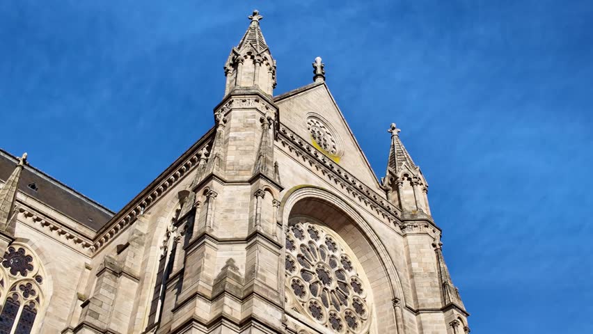 Basilica of Saint-Aubin in Notre-Dame de Bonne-Nouvelle, Rennes, France. Low-angle view with blue sky in background