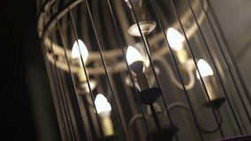 Seven ornate lantern-style chandeliers glow warmly in the night, captured in a slow pan that reveals their vintage charm and ambient elegance, perfect for upscale evening gatherings. - Powered by Shutterstock - Get 15% off with code: PIKWIZARD15