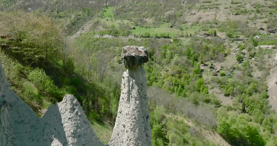 A drone circling the Pyramids of Euseigne in the Herens Valley, Switzerland, capturing the cone-shaped rock formations carved by glacial erosion