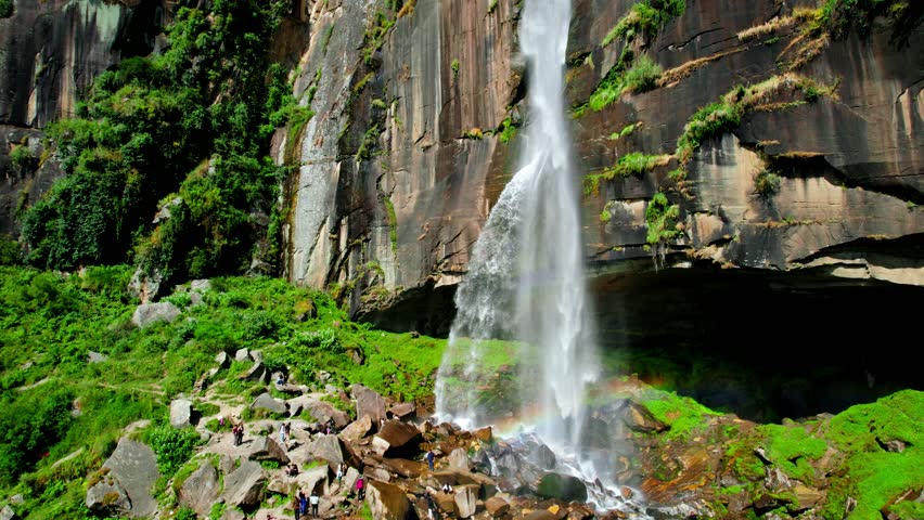4K Aerial view of beautiful rainbow near Jogini waterfall at Manali, Himachal Pradesh, India. Aerial landscape. Flowing water, nature and environment background. Aerial landscape of summer mountain.