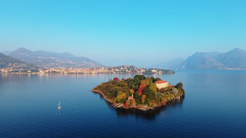 Aerial view of Isola Madre with its palace and botanical garden, contrasting with the deep blue waters, Isola Madre, Stresa, Piedmont, Italy.