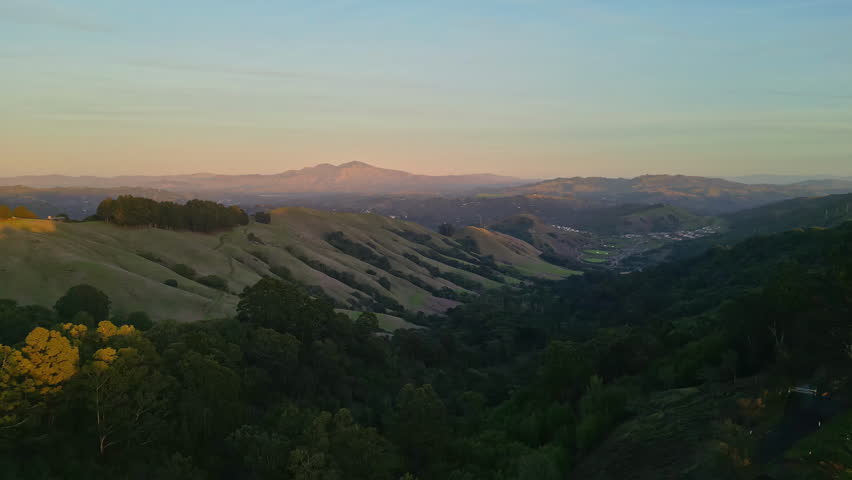 Rolling Green Hills and Valleys at Sunset With Distant Mountains in San Francisco