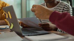 Informal business team collaboration Arabian man examining papers African woman holding chart comunicate Indian male colleague pointing at laptop casual diversity teamwork modern office briefing job - Powered by Shutterstock - Get 15% off with code: PIKWIZARD15