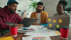 Three business informal diversity workers in meeting office happy success achieve data talking smiling African businesswoman with Hindu men Indian businessmen looking at clipboard document and laptop - Powered by Shutterstock - Get 15% off with code: PIKWIZARD15