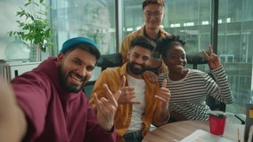 Point of view from phone web camera four diversity coworkers informal business group of managers making selfie photo having fun in office showing thumbs up casual joyful multiethnic people influencers - Powered by Shutterstock - Get 15% off with code: PIKWIZARD15
