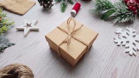 Slow motion close-up of hands securing twine on a holiday gift box with soft minimalist festive decorations - Powered by Shutterstock - Get 15% off with code: PIKWIZARD15